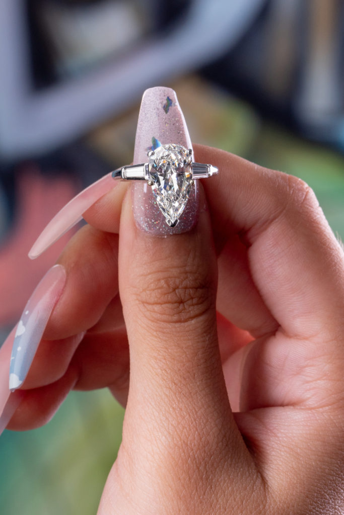 close view of tapered baguettes as accent stones on a three stone ring