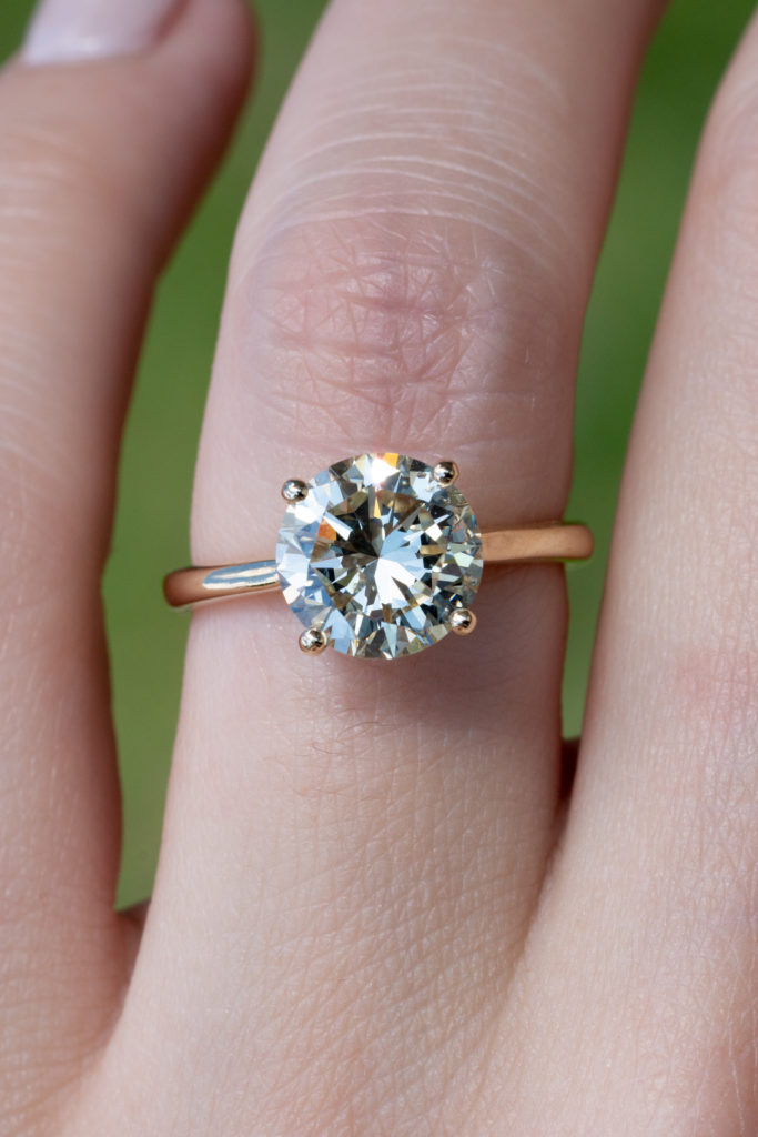 elegant solitaire setting on an engagement ring