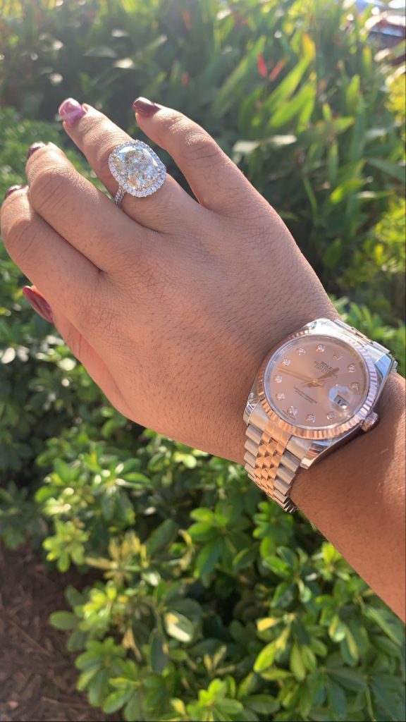 used Rolex watch worn with large engagement ring