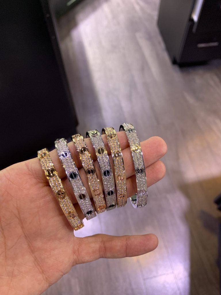 iced out jewelry 6 Cartier love bracelets all diamond in yellow gold and white gold held together