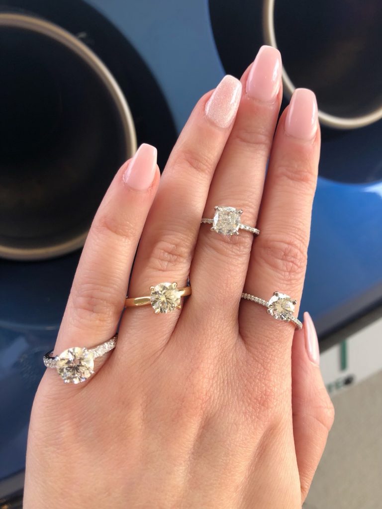 four Diamond engagement rings worn on one hand featuring which diamond cut is best