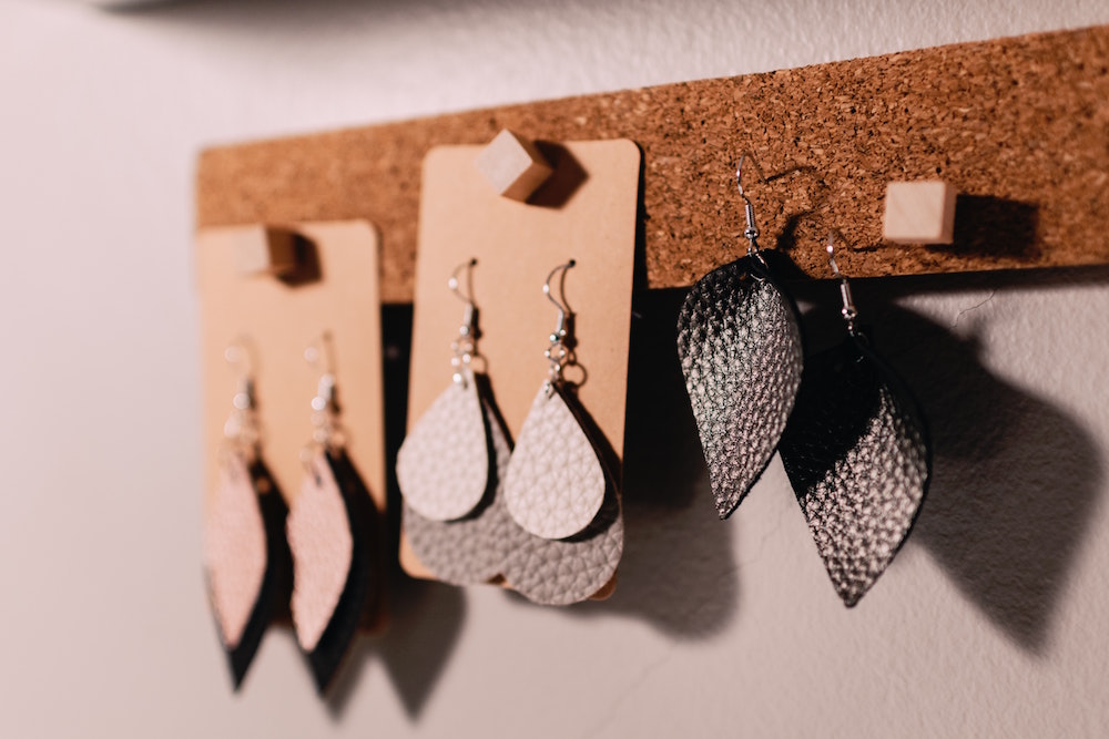 dangle earrings on a corkboard